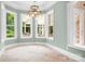 A bright dining area featuring a modern chandelier and large windows at 3204 Mcpherson St, Waxhaw, NC 28173