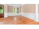 An empty dining room with natural light, hardwood floors, and elegant trimwork at 3204 Mcpherson St, Waxhaw, NC 28173