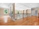 Bright foyer with hardwood floors, decorative ceiling, and wrought iron railing overlooking the entry at 3204 Mcpherson St, Waxhaw, NC 28173
