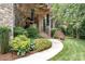 Beautiful stone and brick home with a curving walkway and vibrant landscaping at 3204 Mcpherson St, Waxhaw, NC 28173