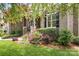 Charming front exterior with brick and stone accents surrounded by lush landscaping at 3204 Mcpherson St, Waxhaw, NC 28173