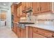 Close-up of a kitchen stove with granite countertops and wooden cabinets at 3204 Mcpherson St, Waxhaw, NC 28173