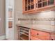 Butler's pantry area with granite countertops, wooden cabinets, and a wine cooler at 3204 Mcpherson St, Waxhaw, NC 28173