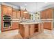Bright kitchen featuring wooden cabinets, granite countertops, and a large center island at 3204 Mcpherson St, Waxhaw, NC 28173