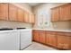 Laundry room with white washer and dryer, cabinets, and a window at 3204 Mcpherson St, Waxhaw, NC 28173