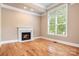 Bright living room with hardwood floors, fireplace, and large window with natural light at 3204 Mcpherson St, Waxhaw, NC 28173