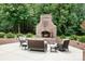 Inviting outdoor patio features a brick fireplace and comfortable seating, perfect for cozy evenings at 3204 Mcpherson St, Waxhaw, NC 28173