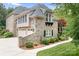 Stone detailing and landscaping surround the side exterior and three car garage at 3204 Mcpherson St, Waxhaw, NC 28173