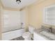 Bathroom with a jetted tub, granite vanity, updated fixtures, and shelving offering a modern and relaxing space at 3209 Lowell Rd, Gastonia, NC 28054
