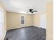 Cozy bedroom includes hardwood floors, neutral paint, and a large window at 3209 Lowell Rd, Gastonia, NC 28054