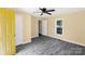 Bright bedroom with a ceiling fan, neutral walls, gray floors, and a window creating a fresh and inviting space at 3209 Lowell Rd, Gastonia, NC 28054