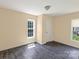 Bright bedroom features hardwood floors, neutral paint, closet, and large window at 3209 Lowell Rd, Gastonia, NC 28054