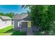 Charming home featuring a bright yellow front door, neutral siding, and well-maintained landscaping at 3209 Lowell Rd, Gastonia, NC 28054