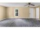 Open-concept living room with neutral walls, gray floors, and a ceiling fan offering a spacious and airy atmosphere at 3209 Lowell Rd, Gastonia, NC 28054
