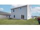 Spacious backyard featuring a well-maintained lawn and a sliding glass door for easy access at 3323 Burberry Dr, Gastonia, NC 28052