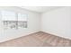 Bright bedroom with large window, plush carpeting, and a minimalist design, perfect for relaxation at 3323 Burberry Dr, Gastonia, NC 28052