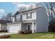 Stylish two-story home featuring a two-car garage, landscaped yard, and a welcoming front entrance at 3323 Burberry Dr, Gastonia, NC 28052