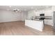 Open-concept kitchen with white cabinets, granite countertops, stainless steel appliances, and a spacious island at 3323 Burberry Dr, Gastonia, NC 28052
