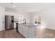 Modern kitchen island features stainless steel appliances, granite countertops, and access to a backyard patio at 3323 Burberry Dr, Gastonia, NC 28052