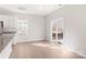 Bright living room featuring light wood flooring, a sliding glass door, and a neutral color palette at 3323 Burberry Dr, Gastonia, NC 28052