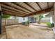 Covered parking leads to backyard, including screened porch and lush green landscape at 34 Admiral Sw Ave, Concord, NC 28027