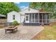Backyard patio area with a screened in porch and mature trees surrounding at 34 Admiral Sw Ave, Concord, NC 28027