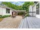 Backyard patio leads to covered parking, steps to deck, and lush landscaping at 34 Admiral Sw Ave, Concord, NC 28027