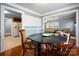 Inviting dining room with hardwood floors, round table and views to kitchen and living area at 34 Admiral Sw Ave, Concord, NC 28027
