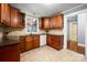 Well-lit kitchen featuring granite countertops, wooden cabinets, and view to the backyard at 34 Admiral Sw Ave, Concord, NC 28027