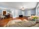 Spacious living room with hardwood floors, flowing into the dining area at 34 Admiral Sw Ave, Concord, NC 28027