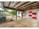 Covered parking and outdoor area showcasing a fire pit and access to the home's entrance at 34 Admiral Sw Ave, Concord, NC 28027