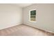 Neutral bedroom features a window view and beige carpet at 3475 Saddlebred Dr, Gastonia, NC 28052