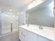 A full bathroom featuring double sinks, vanity with storage, and a glass enclosed shower at 403 Park Meadows Dr, Matthews, NC 28104
