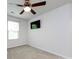 Bright bedroom featuring plush carpeting, a ceiling fan, and a wall-mounted television at 403 Park Meadows Dr, Matthews, NC 28104
