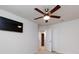 This bedroom offers a ceiling fan and a mounted TV, with doorways to additional rooms at 403 Park Meadows Dr, Matthews, NC 28104