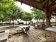 Shot from inside a pergola of a stone-paved community gathering area with outdoor seating at 403 Park Meadows Dr, Matthews, NC 28104