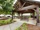 View of a wooden pergola in a community gathering space with tables and bench seating at 403 Park Meadows Dr, Matthews, NC 28104
