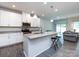 Bright, open kitchen boasts granite countertops, stainless appliances, and an island with bar seating at 403 Park Meadows Dr, Matthews, NC 28104
