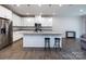 Bright, open kitchen featuring a large island with seating, modern appliances, and sleek countertops at 403 Park Meadows Dr, Matthews, NC 28104