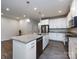 Well-lit kitchen featuring stainless steel appliances, granite countertops and a spacious center island at 403 Park Meadows Dr, Matthews, NC 28104