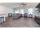 Inviting living room with a ceiling fan, comfortable seating, and large windows for natural light at 403 Park Meadows Dr, Matthews, NC 28104