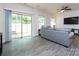 Bright living room with sliding glass doors to the backyard, comfortable sofa, and ceiling fan at 403 Park Meadows Dr, Matthews, NC 28104