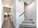 Entryway with carpeted stairs and a wood railing, leading to an open living space at 403 Park Meadows Dr, Matthews, NC 28104