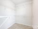 A roomy walk-in closet with carpet and wire shelves is ready for your personal organization ideas at 403 Park Meadows Dr, Matthews, NC 28104