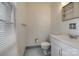Bathroom featuring blue tile floor, white fixtures, and window with blinds at 409 Scaleybark Rd, Charlotte, NC 28209