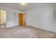 Bedroom featuring neutral walls, carpet, closet, and an ensuite bathroom at 409 Scaleybark Rd, Charlotte, NC 28209