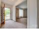 Welcoming foyer with carpet and a view into a large living room with windows at 409 Scaleybark Rd, Charlotte, NC 28209
