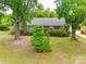 Brick home with large trees and landscaping, providing shade and curb appeal at 409 Scaleybark Rd, Charlotte, NC 28209