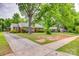 Charming brick home with mature trees, manicured landscaping, and a welcoming entrance at 409 Scaleybark Rd, Charlotte, NC 28209