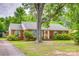 Charming brick home featuring mature trees and a well-maintained front yard at 409 Scaleybark Rd, Charlotte, NC 28209
